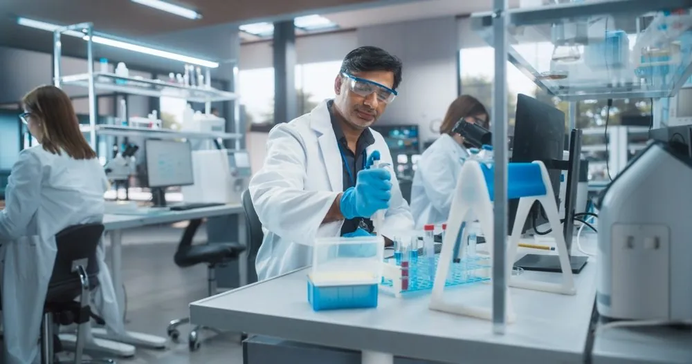 A laboratory technician working with sample tubes